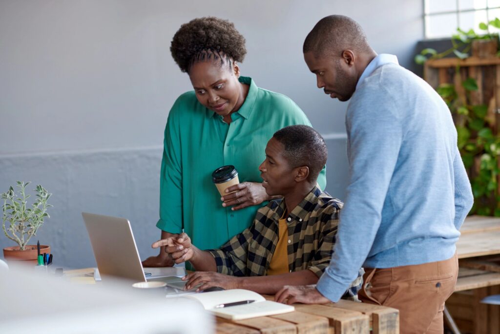 African businesspeople at work on a laptop in an office