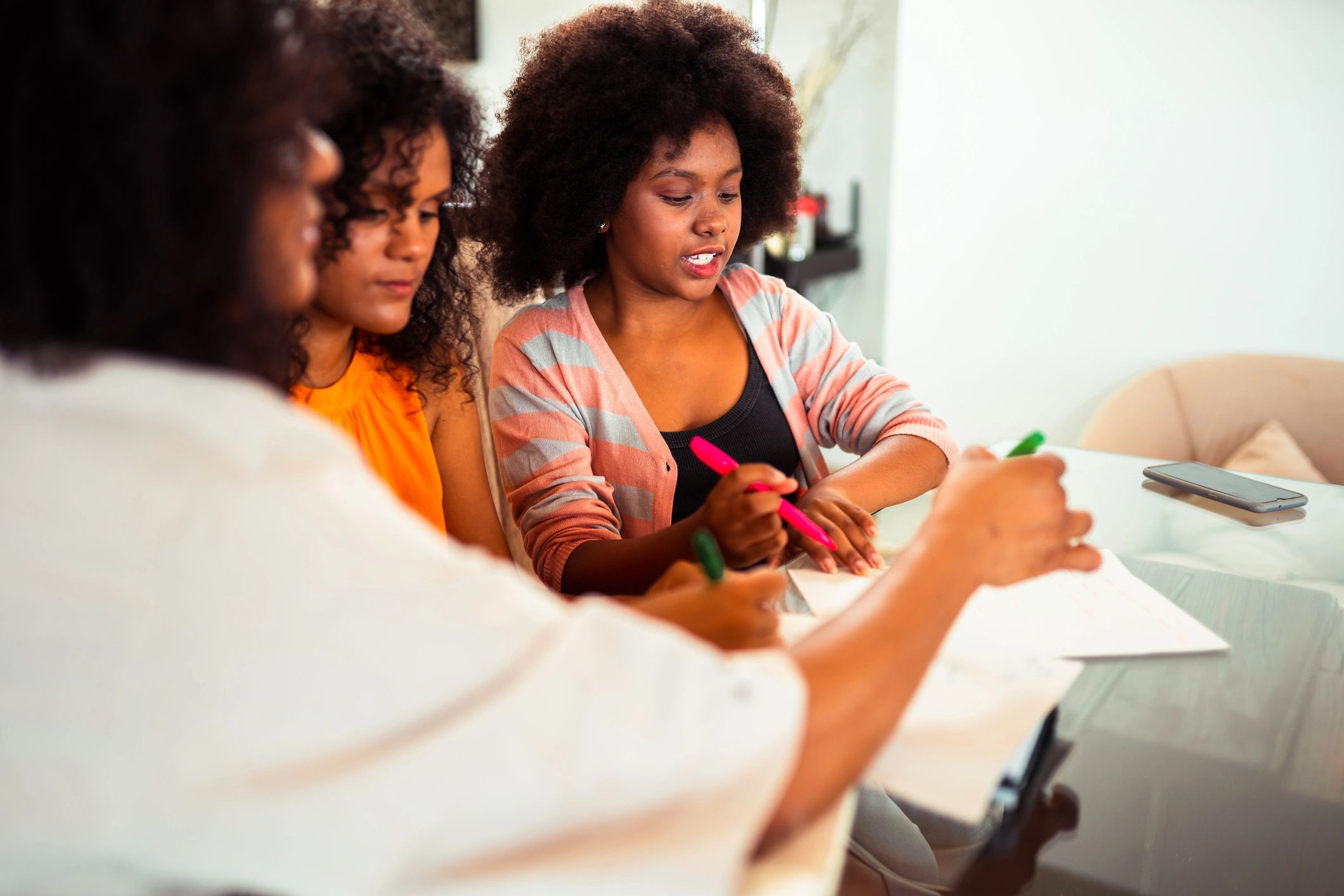 Black women collaborating around a table during a planning discussion